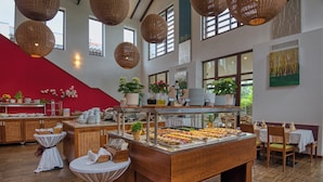 A buffet area with various food items, wicker baskets, and potted plants. - Tisza Balneum Thermal Hotel (Tiszafured)