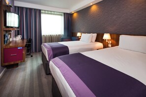 A hotel room with two beds, a desk with a computer, a TV, and a minibar. - Holiday Inn Express Lincoln City Centre by IHG (Lincoln)