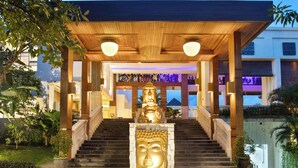 A covered entrance with a staircase leading to a building, surrounded by greenery. - Tonys Villas & Resort (Keroboken Kelod)