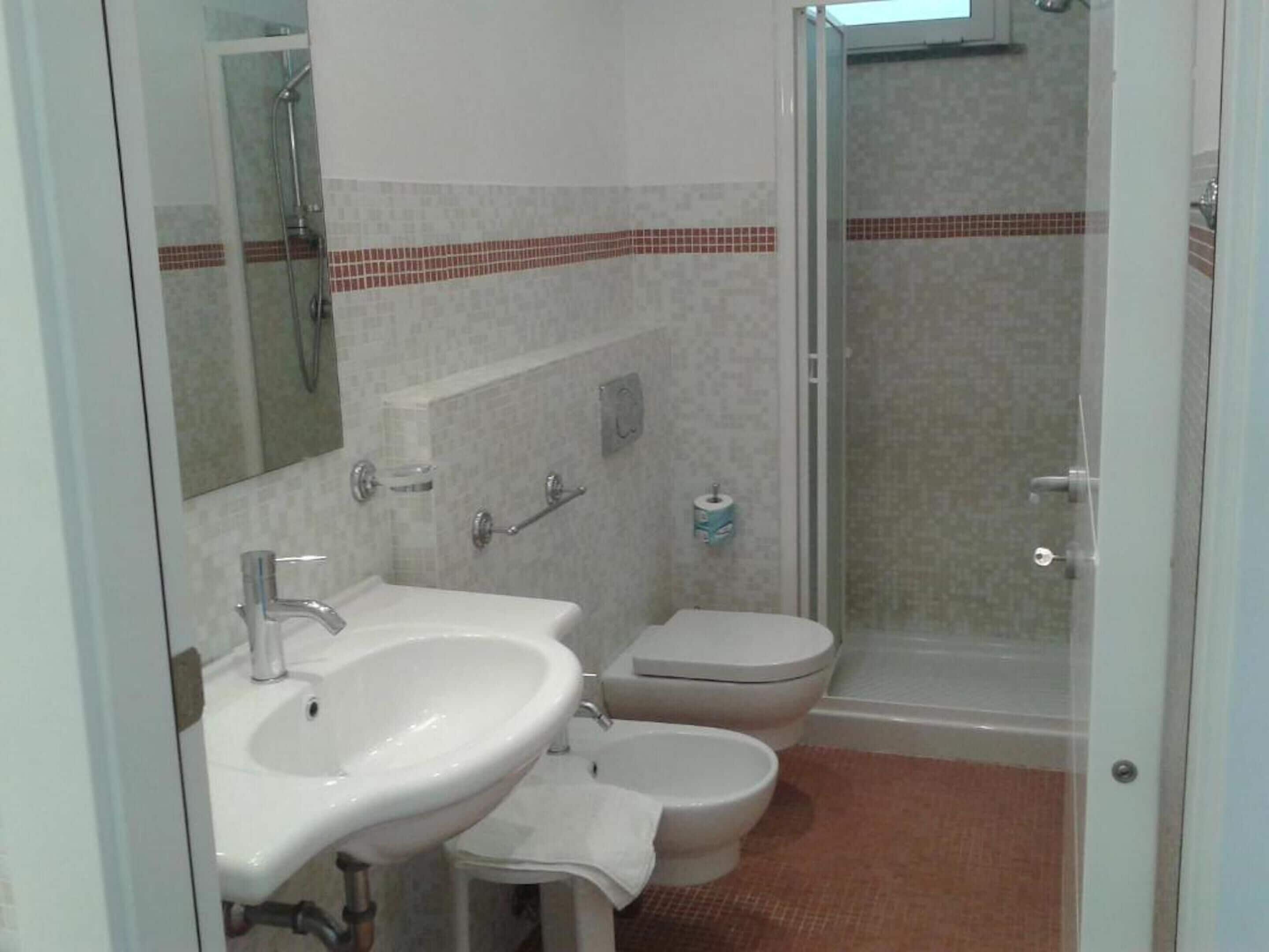 Ein Badezimmer mit Waschbecken, Toilette und Dusche.