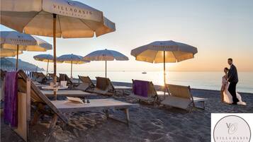 Private beach, black sand, sun-loungers, beach umbrellas