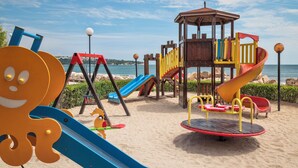 A beachside playground with slides and climbing structures. - Sol Luna Bay Resort (Byala)