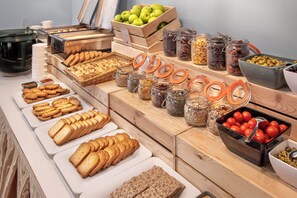 A buffet spread with various food items including bread, fruits, and condiments. - Sol Luna Bay Resort (Byala)