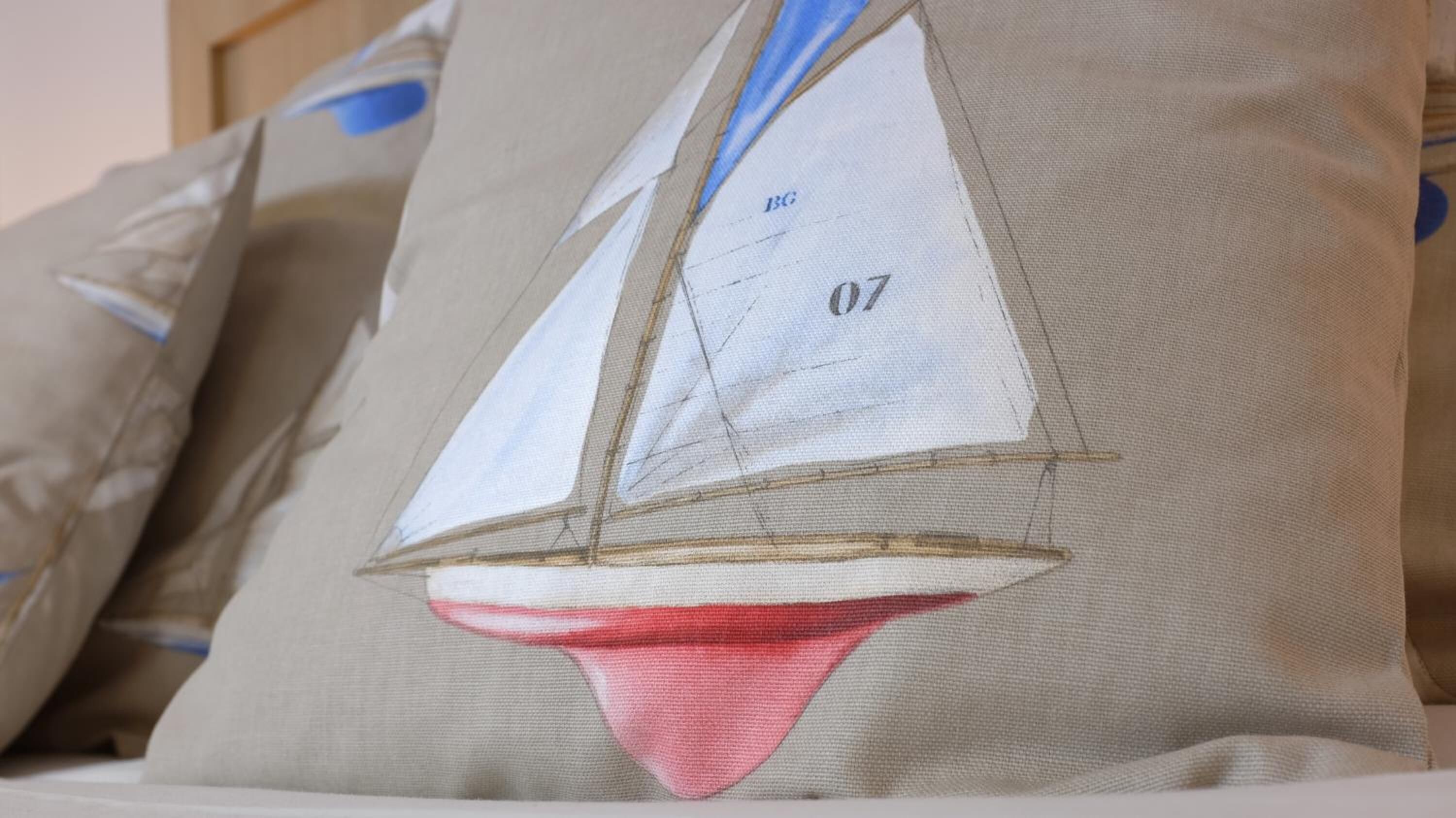 A pillow with a sailboat design.