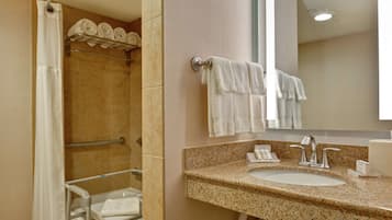 A bathroom with a sink, mirror, and towel rack.
