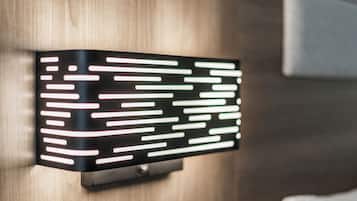 A modern wall-mounted light fixture with horizontal lines.