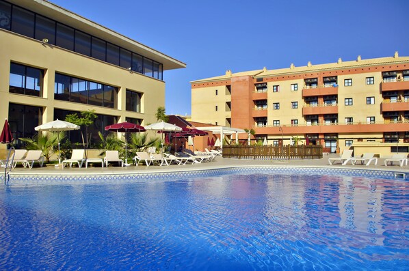 Seasonal outdoor pool, open noon to 8:00 PM, pool umbrellas