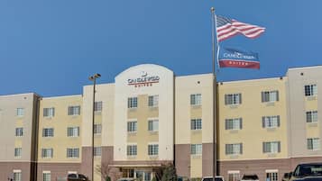 A hotel with a prominent sign, multiple windows, and a flag.