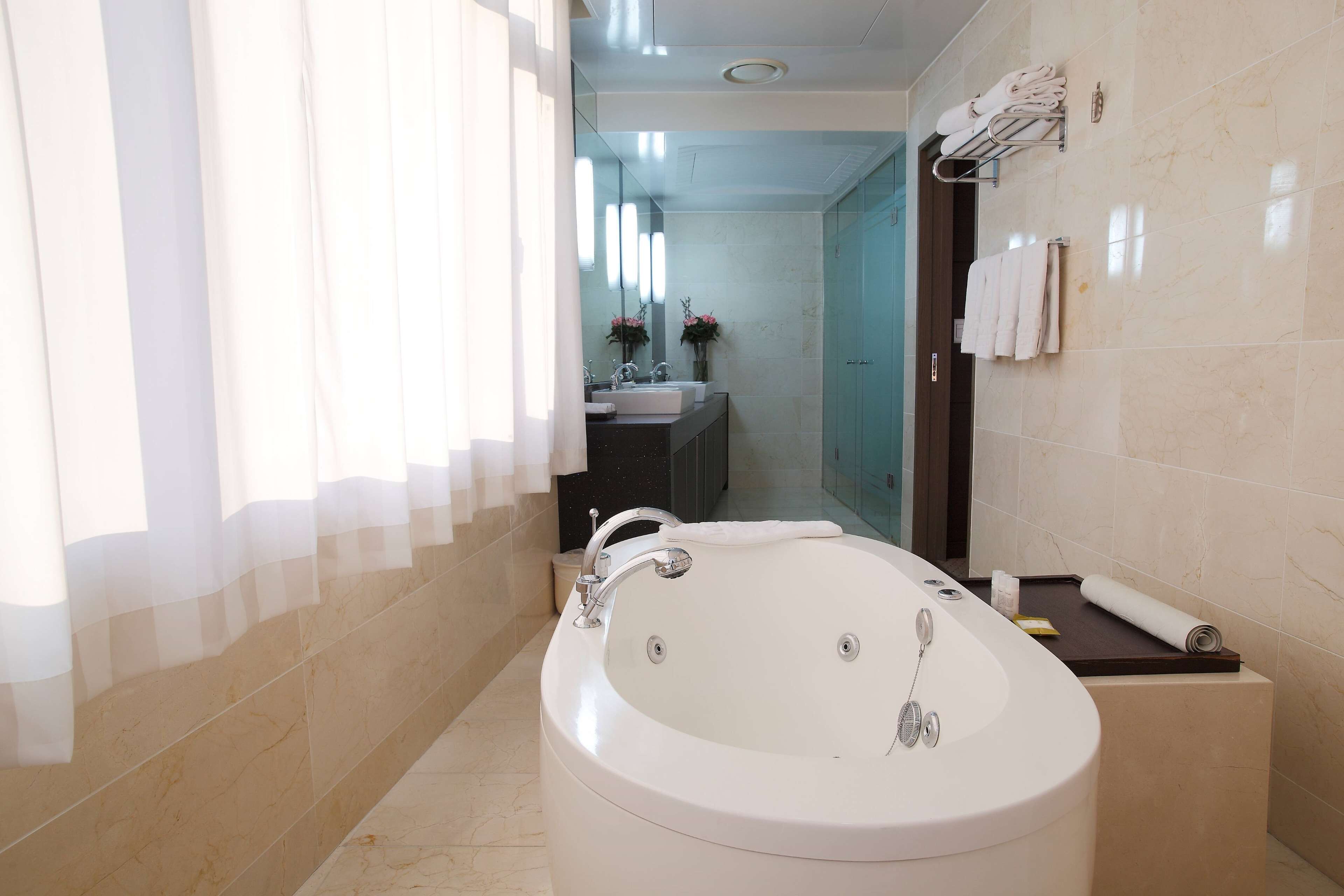 suite, 1 queen bed, hot tub | bathroom | combined shower/bathtub, free toiletries, hair dryer, bathrobes