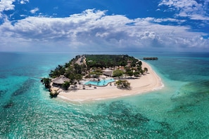 An aerial view of a tropical island with a beach, a swimming pool, and overwater bungalows. - Bawe Tropical Island (Bawe Island)