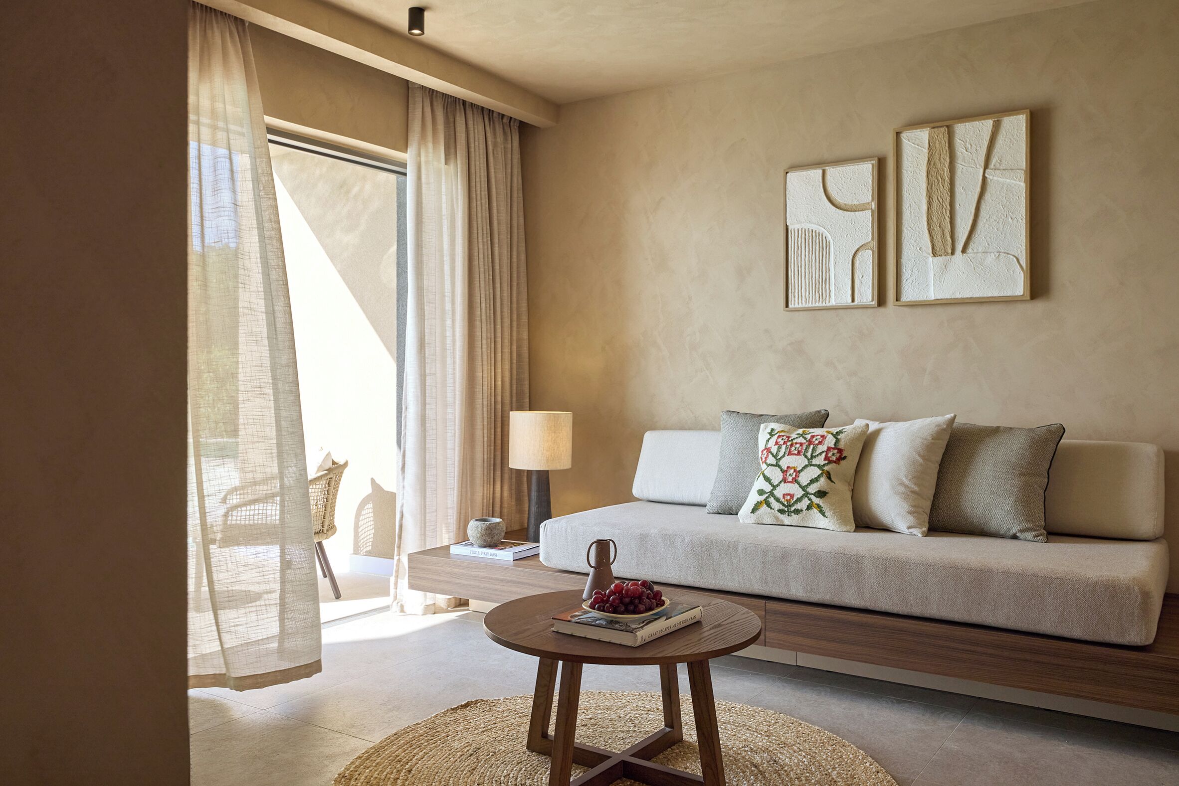 A modern living room with a sofa, a coffee table, and artwork on the wall.