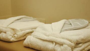 A stack of white towels on a beige surface.