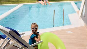 Seasonal outdoor pool, open 9:00 AM to 6:00 PM, pool umbrellas