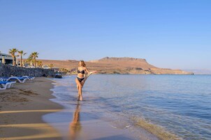 On the beach, sun-loungers, beach umbrellas, beach towels
