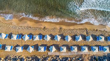 On the beach, sun-loungers, beach umbrellas, beach towels