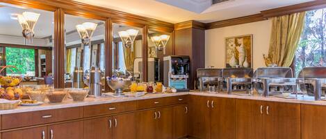 A spacious kitchen with wooden cabinets, a large breakfast bar, and a coffee station.