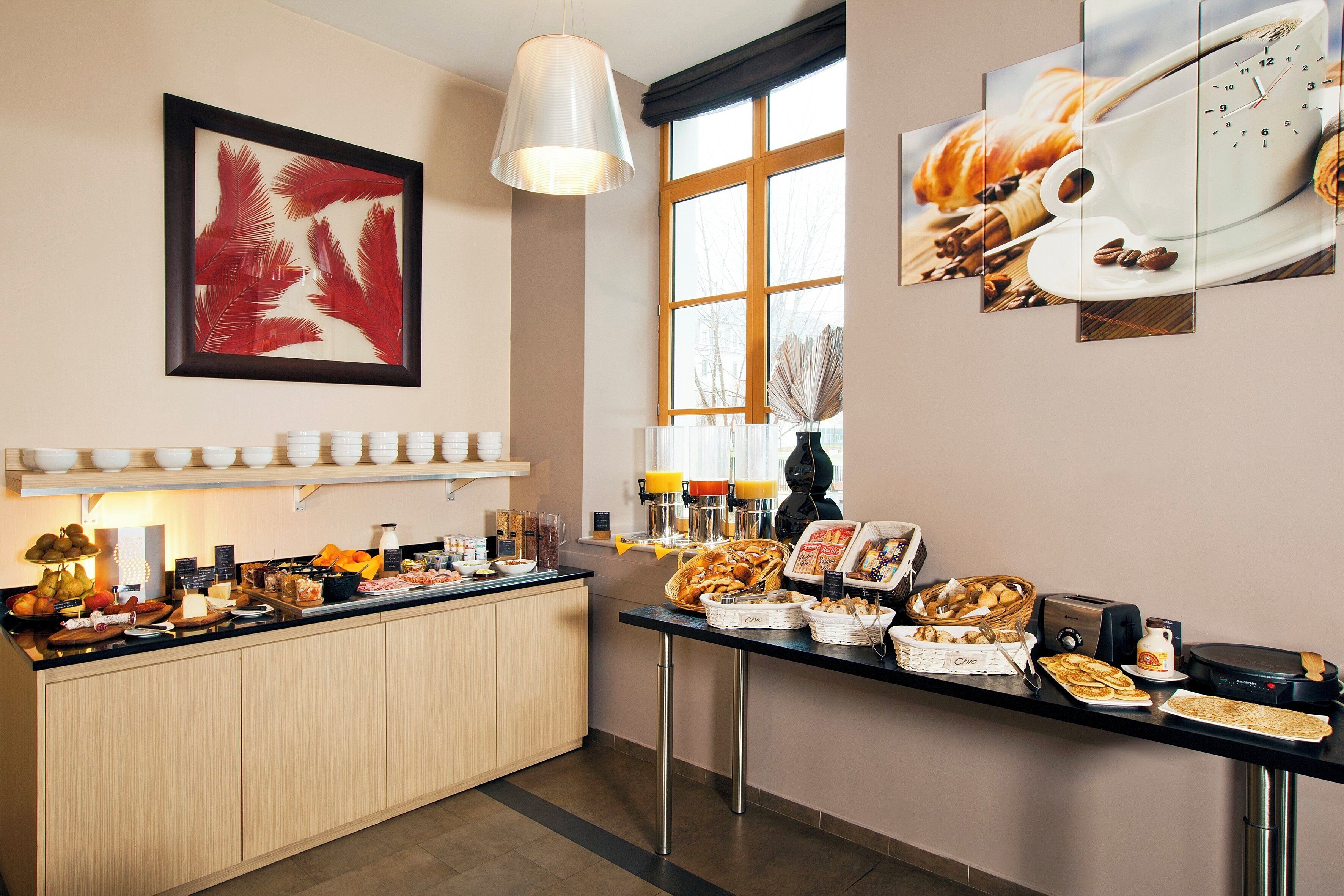 A breakfast buffet with various food items and a coffee station.