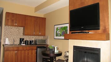A compact living space with a kitchen, dining area, and a fireplace.