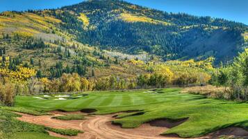 Play amidst the serene mountainous landscape, where well-maintained greens and sand bunkers await.