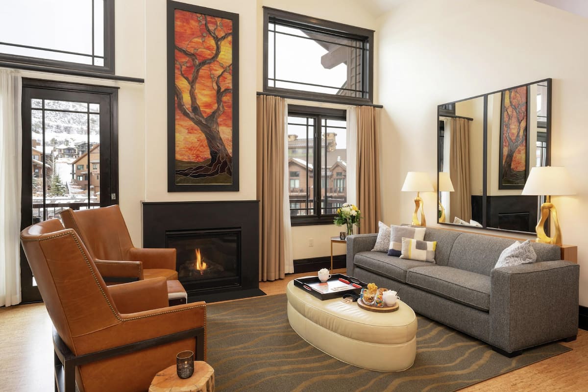 A living room with a fireplace, a sofa, a chair, and a coffee table.