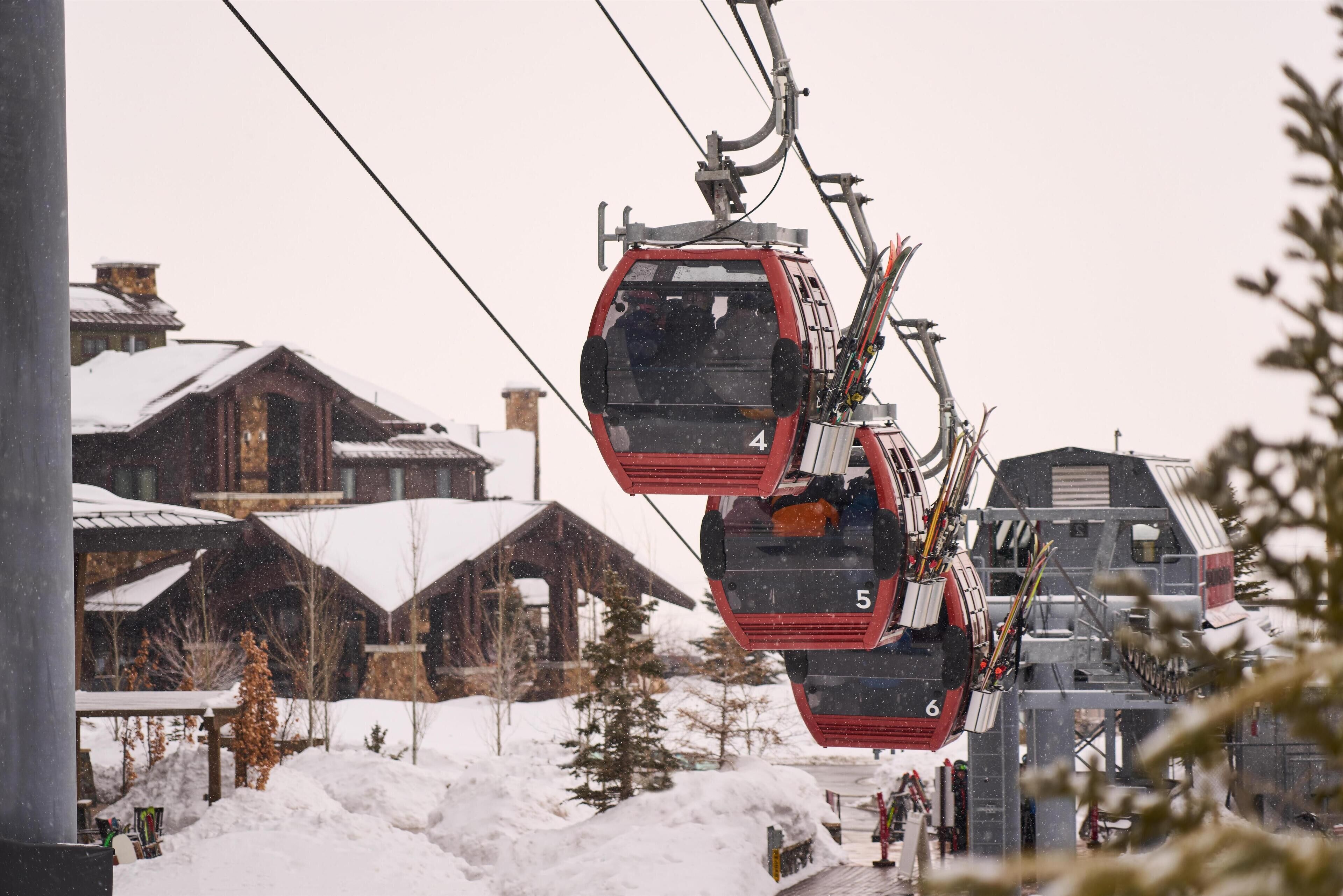 A ski lift with cabins numbered 4, 5, and 6, suspended by cables.