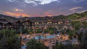 A resort with multiple lodging units, a swimming pool, and a mountainous backdrop. - Waldorf Astoria Park City (Park City)