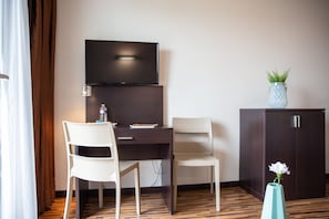Relax in this stylish room with a flat-screen TV, desk, and comfortable seating area.