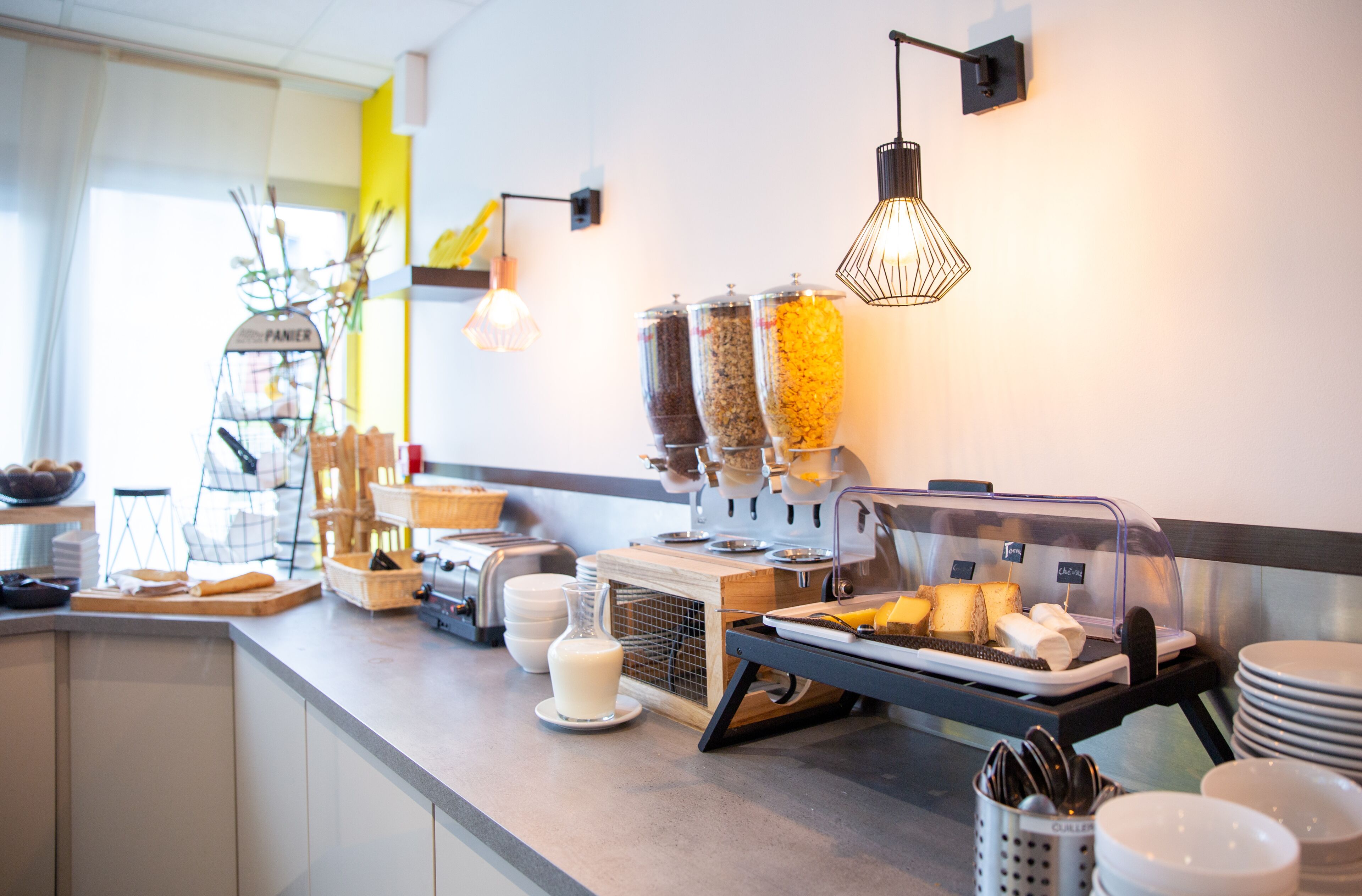 A breakfast buffet setup with various food items and condiments.