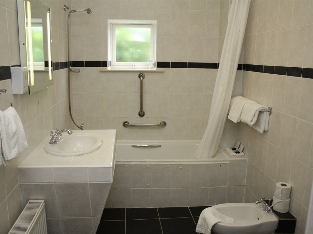 A bathroom with a sink, bathtub, and toilet.