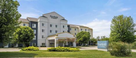 A Fairfield by Marriott hotel with a modern design, featuring a central entrance, multiple floors, and a well-maintained lawn area.
