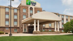 Edificio di un Holiday Inn Express & Suites, con facciata in pietra, ampie finestre e un'area d'ingresso coperta.