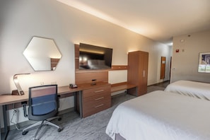 A hotel room with a desk, a chair, a bed, a wardrobe, and a mirror. - Holiday Inn Express Hotel & Suites, a Lake Zurich-Barrington by IHG (Lake Zurich)