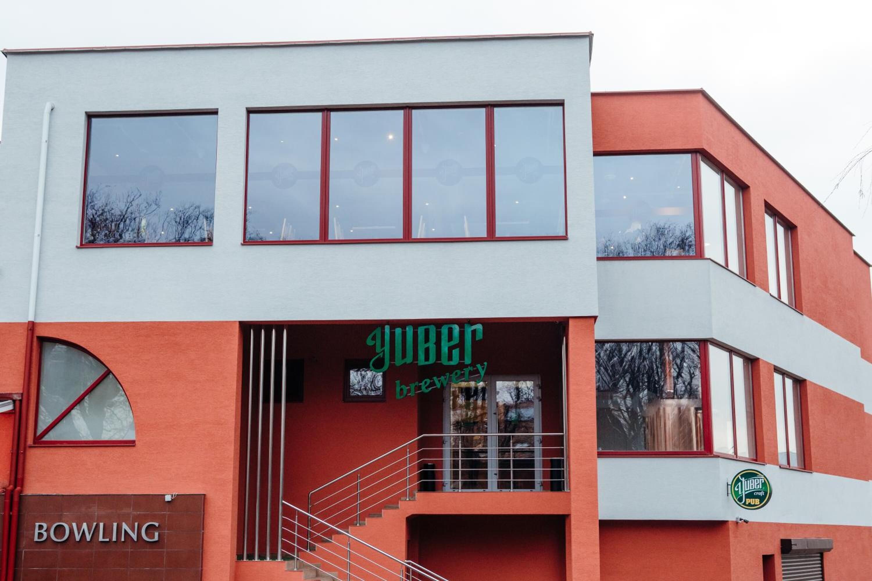 A building with a sign reading "Yuber Brewery" and a sign for "BOWLING" below it.