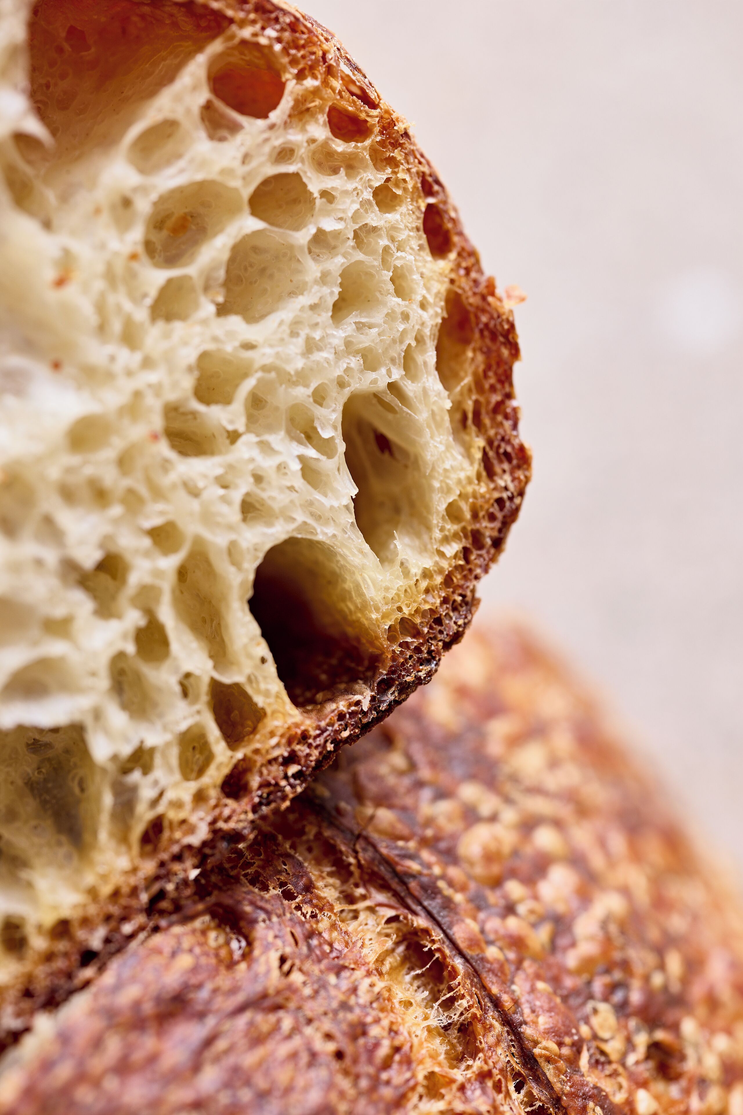A close-up of a loaf of bread with a textured crust and porous interior.