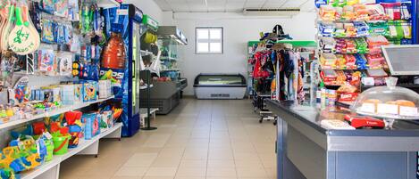 A store with shelves stocked with toys, snacks, and other items.