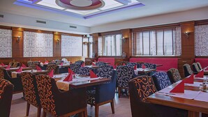 A conference room with multiple tables and chairs, equipped with nameplates and table settings. - Airport Global Hotel  (Moerfelden-Walldorf)