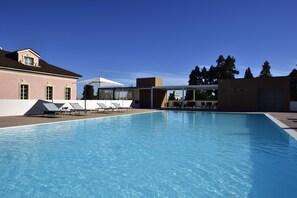 A swimming pool with lounge chairs and a covered seating area. - Castello Dal Pozzo Resort Lago Maggiore - Preferred Hotels & Resorts (Oleggio Castello)