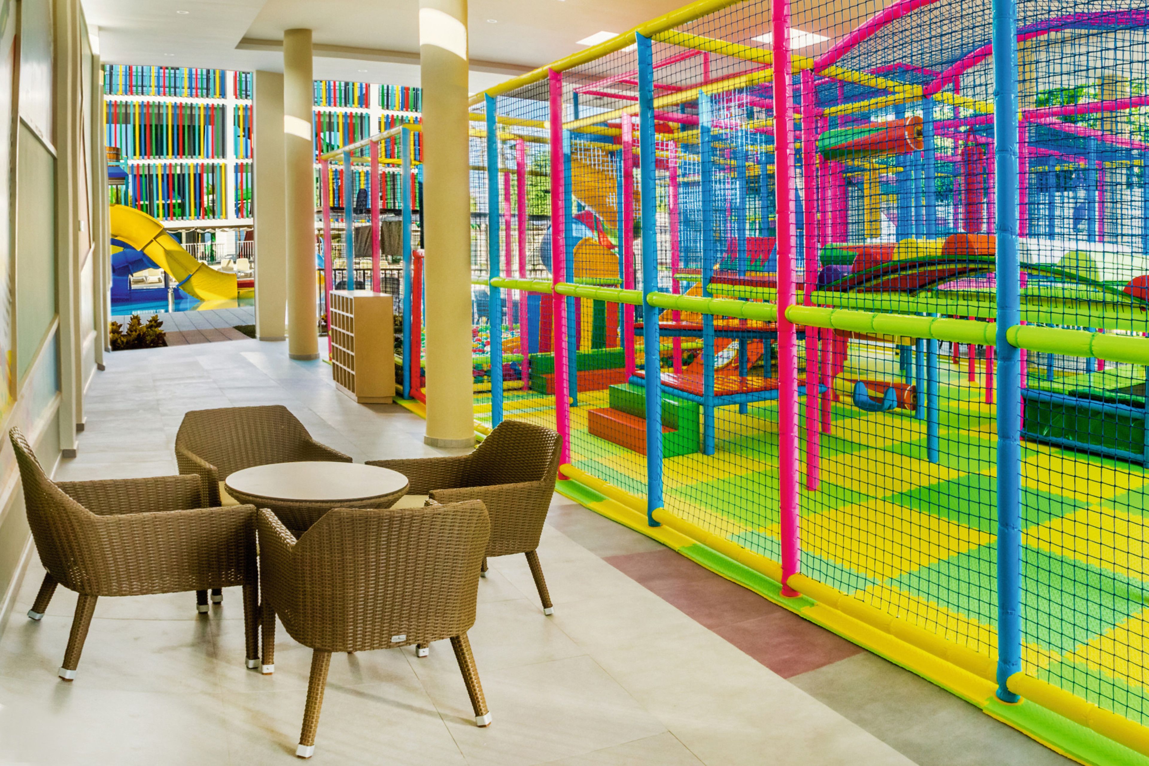 A children's play area with colorful netted structures and a slide.