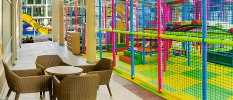 A children's play area with colorful netted structures and a slide.