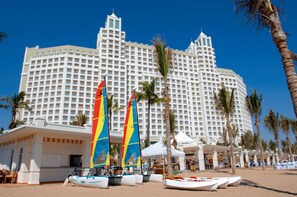 A large hotel with multiple floors and a beachside location.