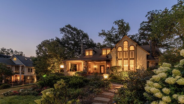 A large, two-story house with a stone facade, a prominent front porch, and a well-maintained garden with a stone pathway leading to the entrance. - Stonehurst Place Bed & Breakfast (Atlanta)