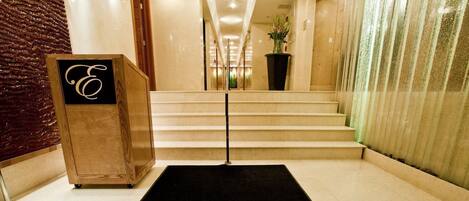 A hotel entrance with a black carpet displaying 'The Eldon Washington DC' in gold lettering.