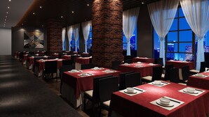 A restaurant with multiple tables, each set with white plates and bowls, and a cityscape view through large windows. - Henry Business Hotel (Guangzhou)