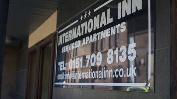 A sign for International Inn, indicating it is a serviced apartment complex.