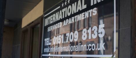 A sign for International Inn, indicating it is a serviced apartment complex.