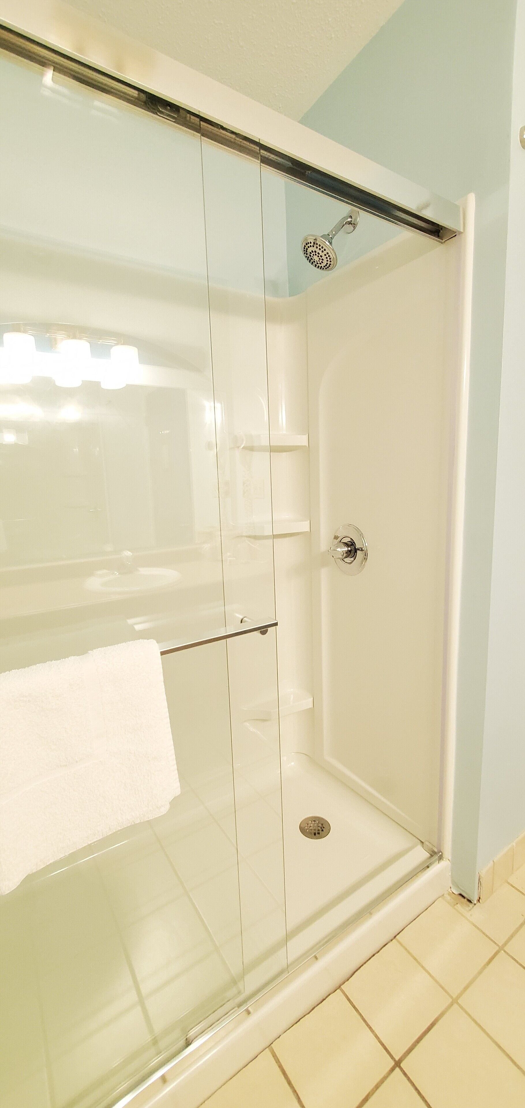 deluxe quadruple room, 2 queen beds | bathroom shower