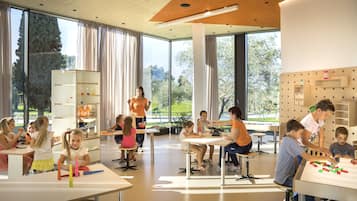 Learning takes place in this bright, spacious room with large windows, tables for hands-on activities, and ample storage.