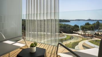 A balcony with a view of a body of water and a distant landscape.