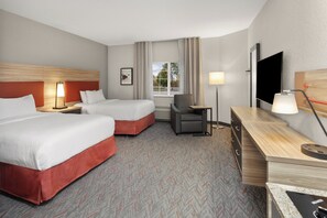 A hotel room with two beds, a desk, a chair, a TV, and a window with curtains. - Candlewood Suites Elgin by IHG (Elgin)