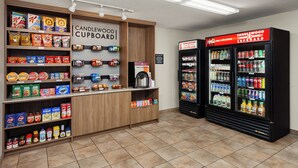A self-service beverage station with a variety of drinks and snacks.